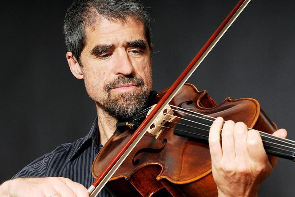 A close up colour photograph of Thomas Riebl playing the viola
