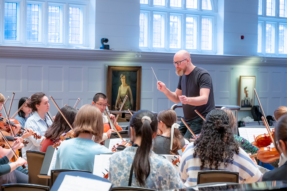 Ben Palmer conducts an orchestra