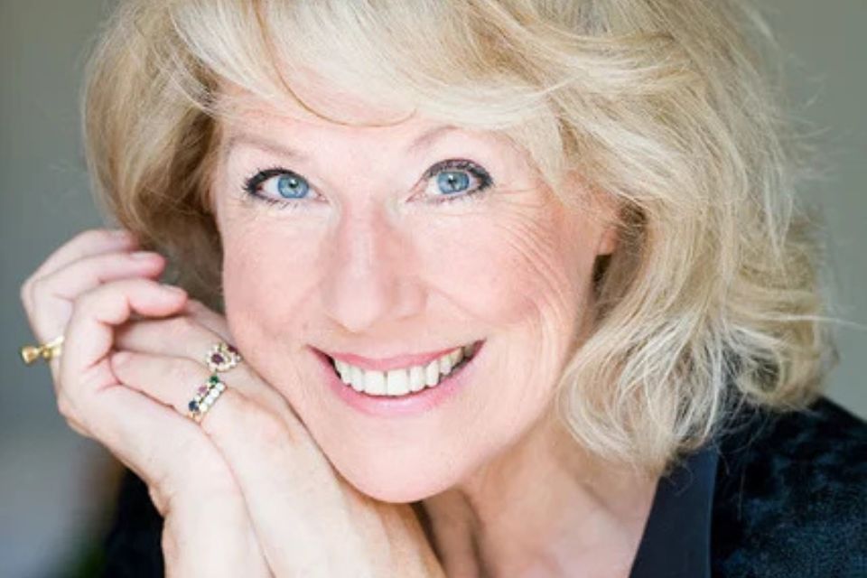 Edith Wiens rests her chin on her hands and smiles