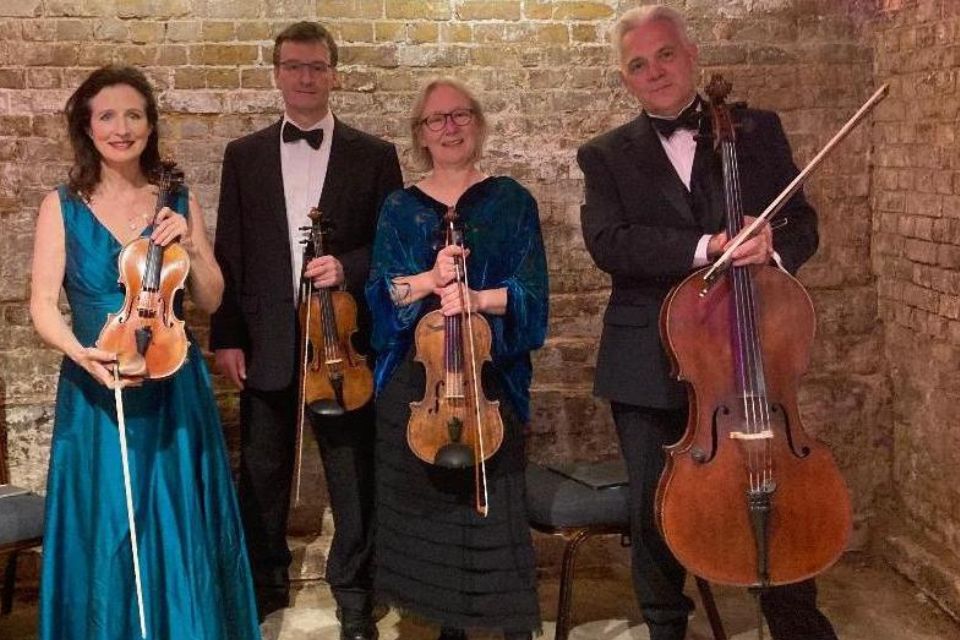 The London Chamber Ensemble wear black and hold their instruments