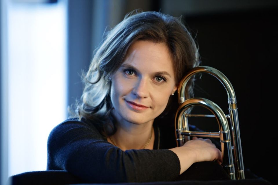 Line Johannesen holds her trombone and smiles