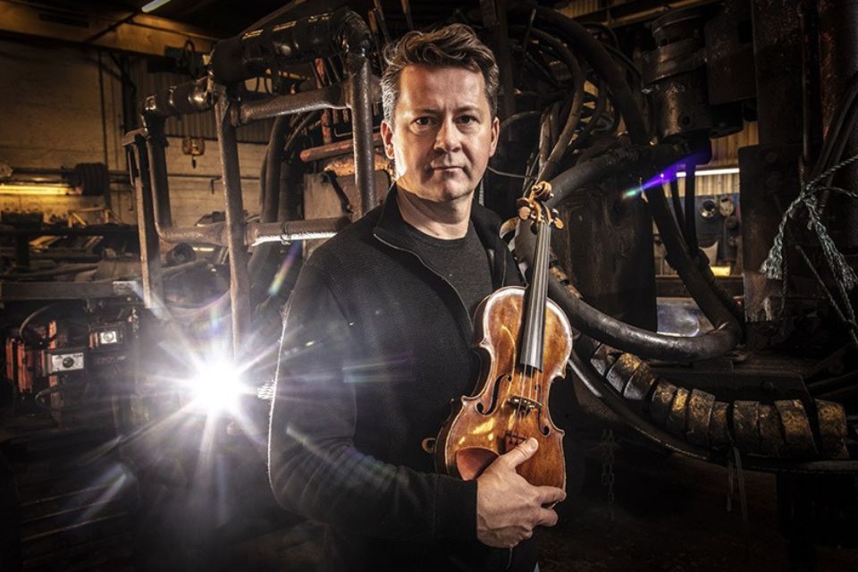 Peter Herresthal, wearing dark blue, looks to camera