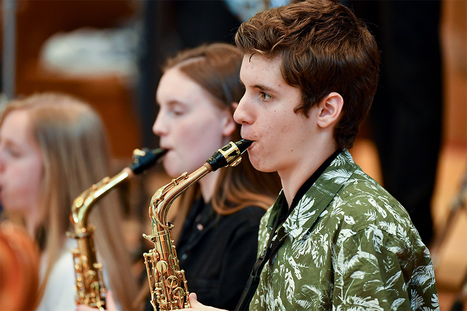 Two students from the Junior Department play the saxophone