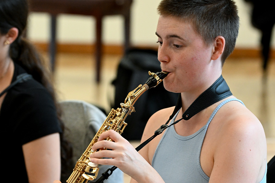 A saxophonist plays her instrument passionately