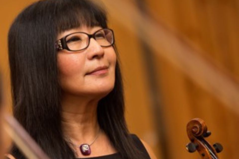 Soon-Mi Chung Barratt-Due wears black glasses and holds her viola, looking up