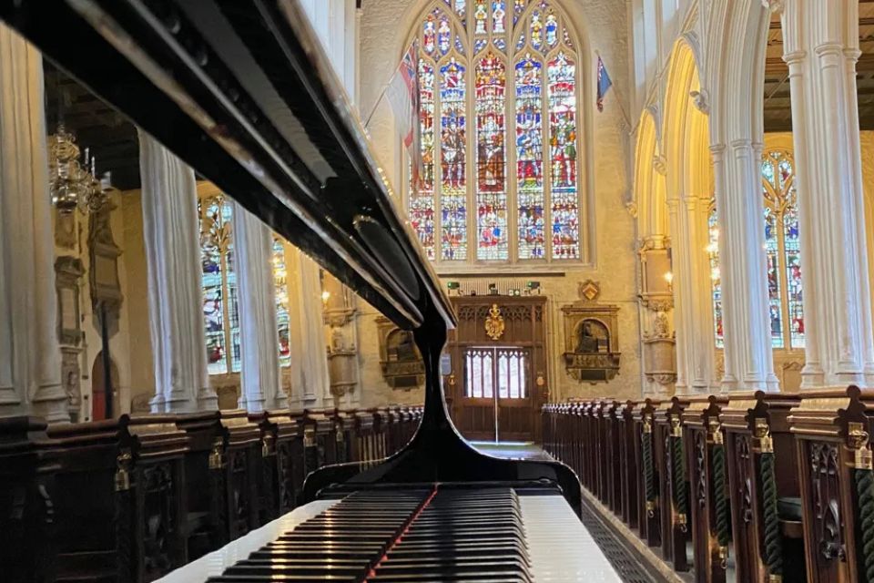 A shiny piano in a church hall