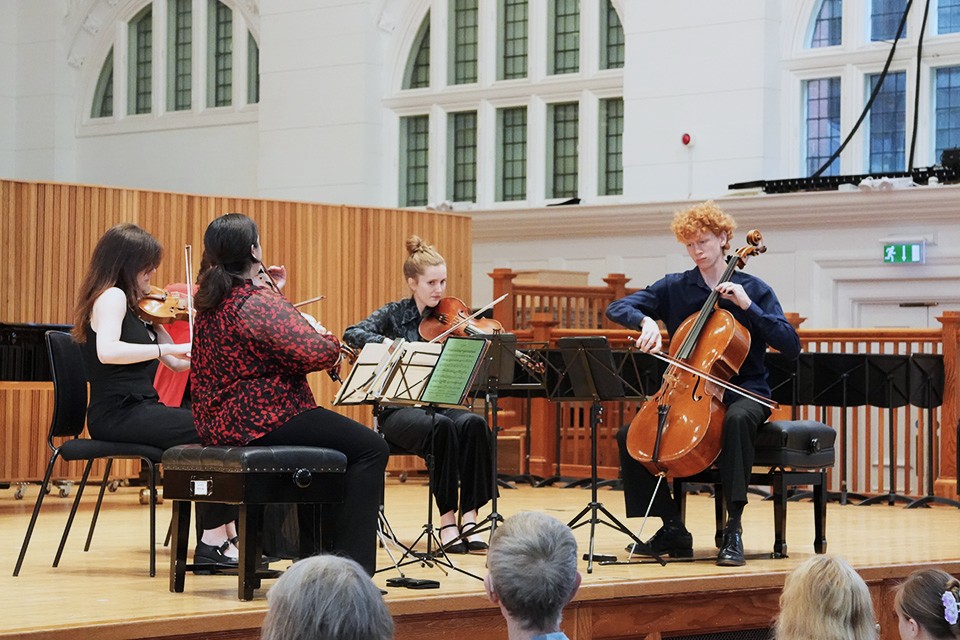 A string quartet performs on stage