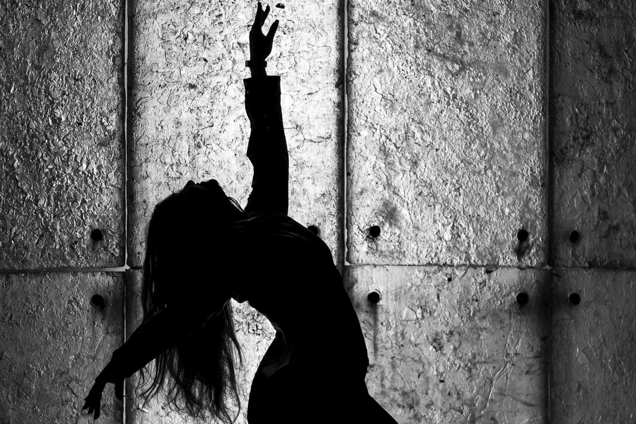 A black and white silhouette of a dancer