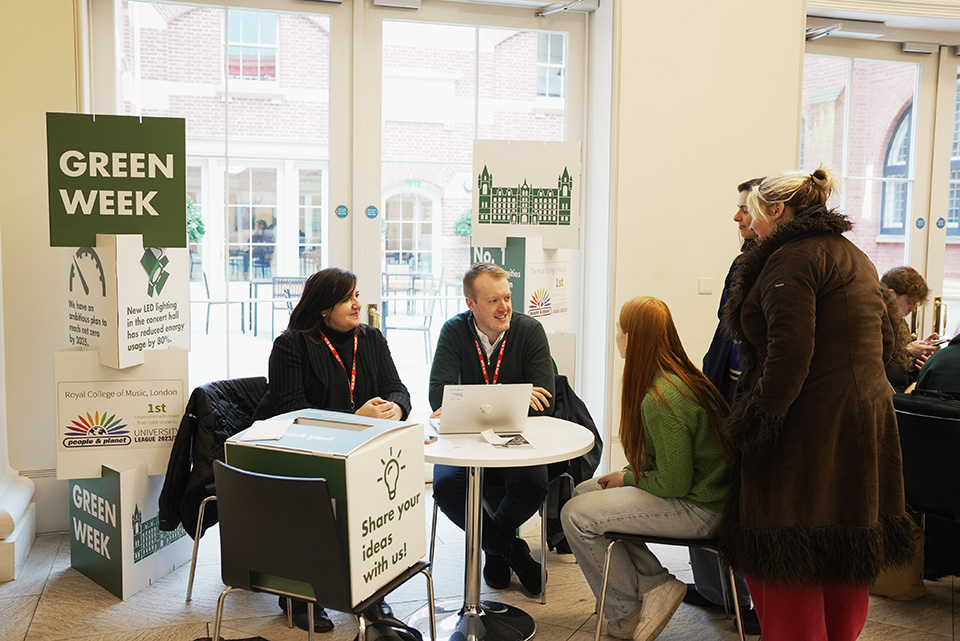 A member of staff listening to ideas from students in a cafetest