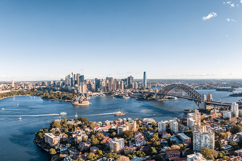 Image of a city skyline with a big bridge across the water 