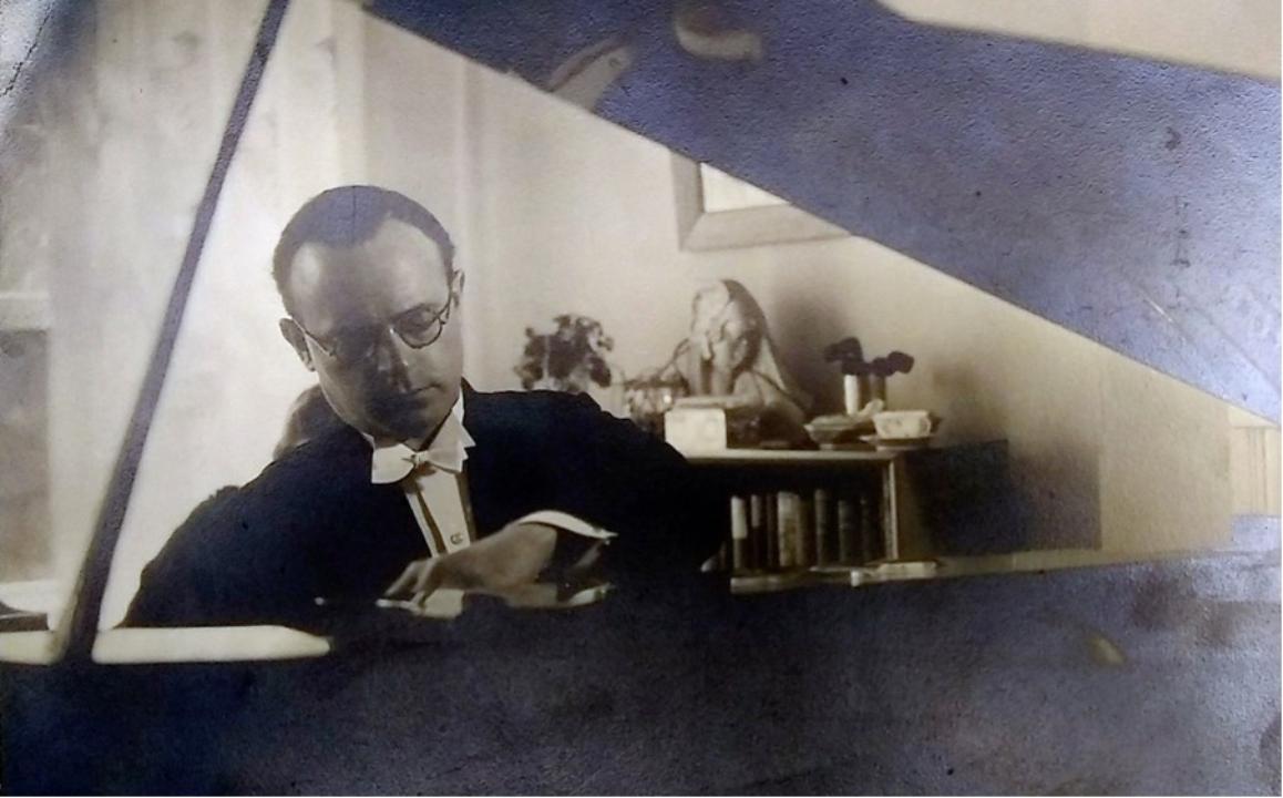 Ferdinand Rauter, a man wearing a tuxedo looking down and appears to be playing a piano Ferdinand Rauter, a man wearing a tuxedo looking down and appears to be playing a piano
